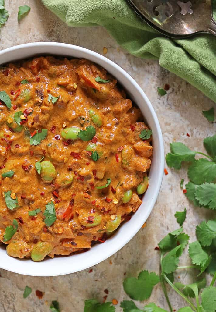 Delicious Edamame curry garnished with parsley and red pepper flakes