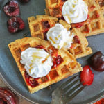 Tasty Almond Flour Waffles Dairy-free and grain-free slathered with raspberry preserves and whipped topping.