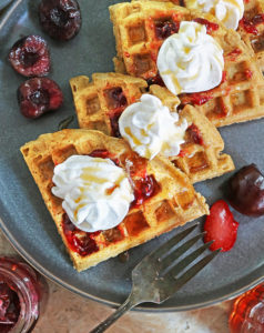Tasty Almond Flour Waffles Dairy-free and grain-free slathered with raspberry preserves and whipped topping.