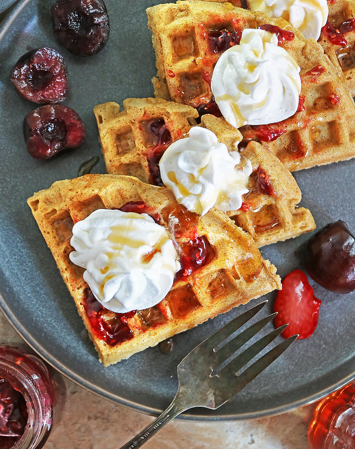 Tasty Almond Flour Waffles Dairy-free and grain-free slathered with raspberry preserves and whipped topping.