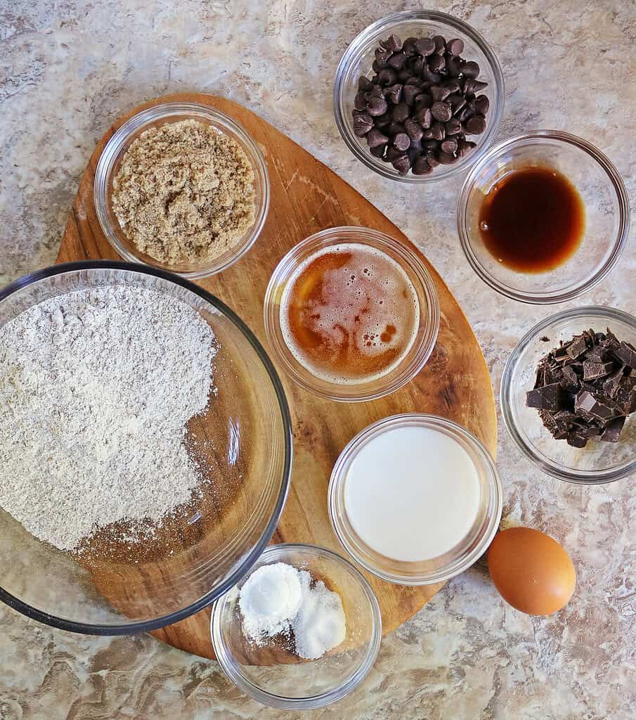 9 ingredients needed to make Brown Butter Rye Muffin Tops on a board.