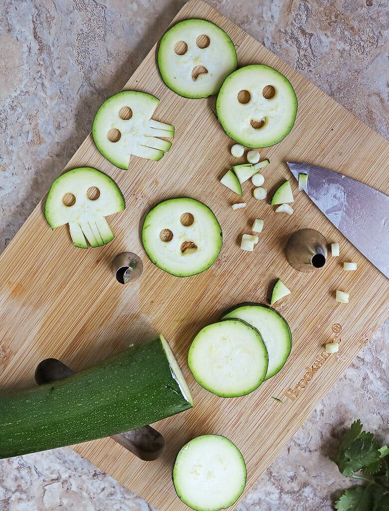 Cutting fun shapes into zucchini which makes this dish a fun one for Halloween for kids and those young at heart
