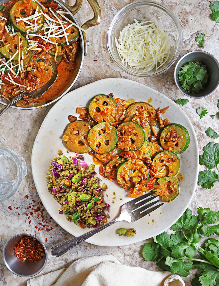 Delicious Easy Marry me zucchini served with some moong bean quinoa and veggies. There's also some Parmesan and parsley on the side.