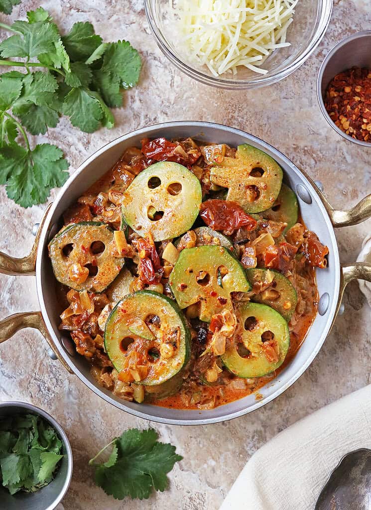 Marry me zucchini in a pan with some parsley on the side