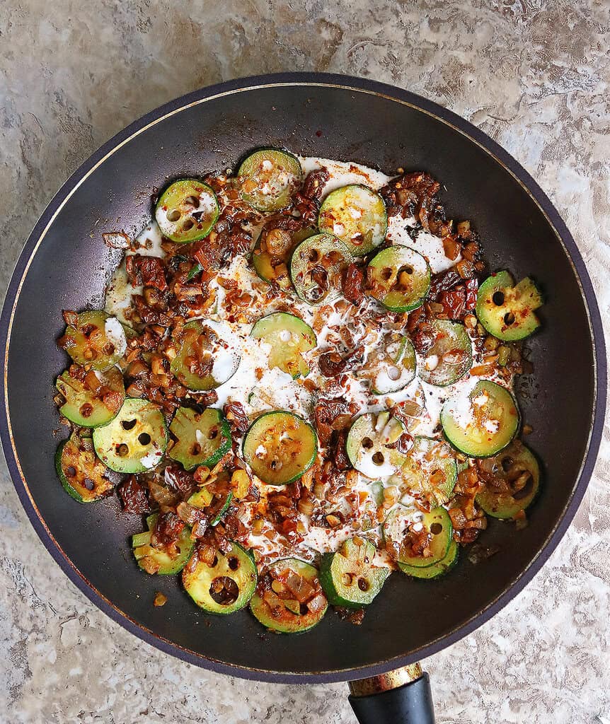 Zucchini, onions, spices, sundried tomatoes simmering with coconut milk added in