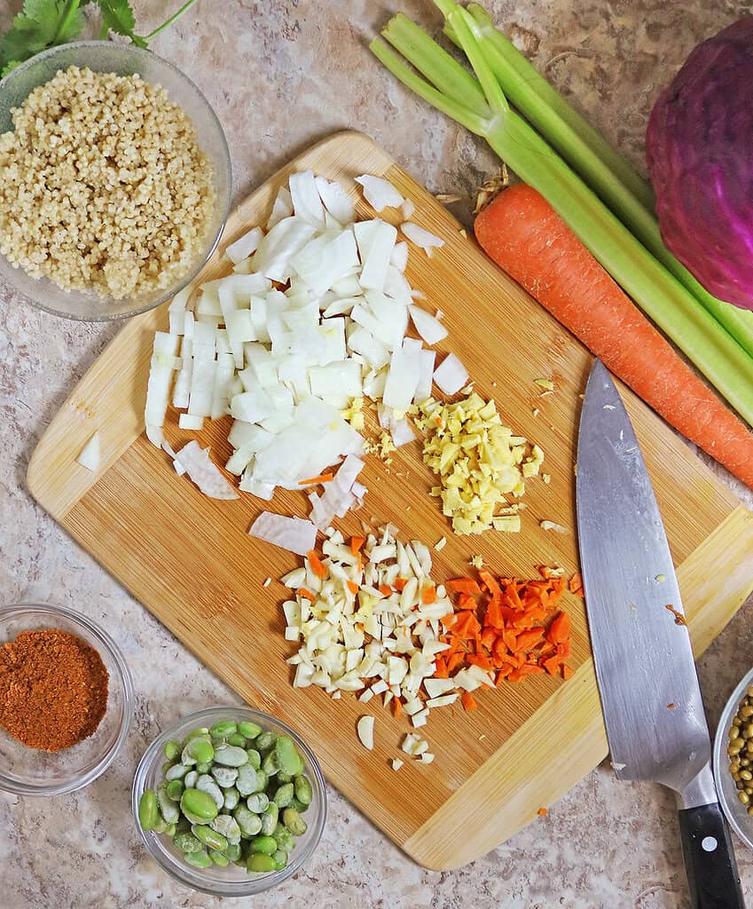chopping up onion ginger garlic and turmeric