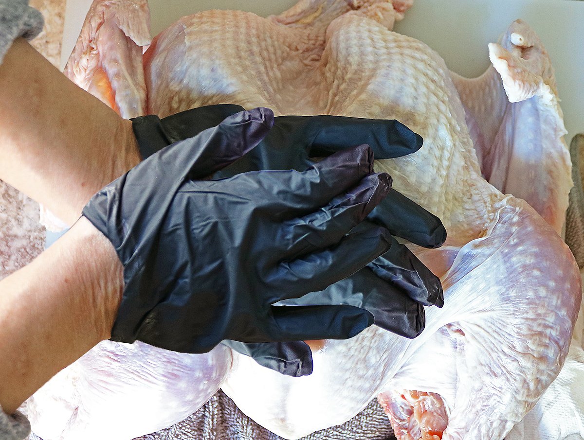 Flatten the breast bone by placing both hands aon the breast and pressing down