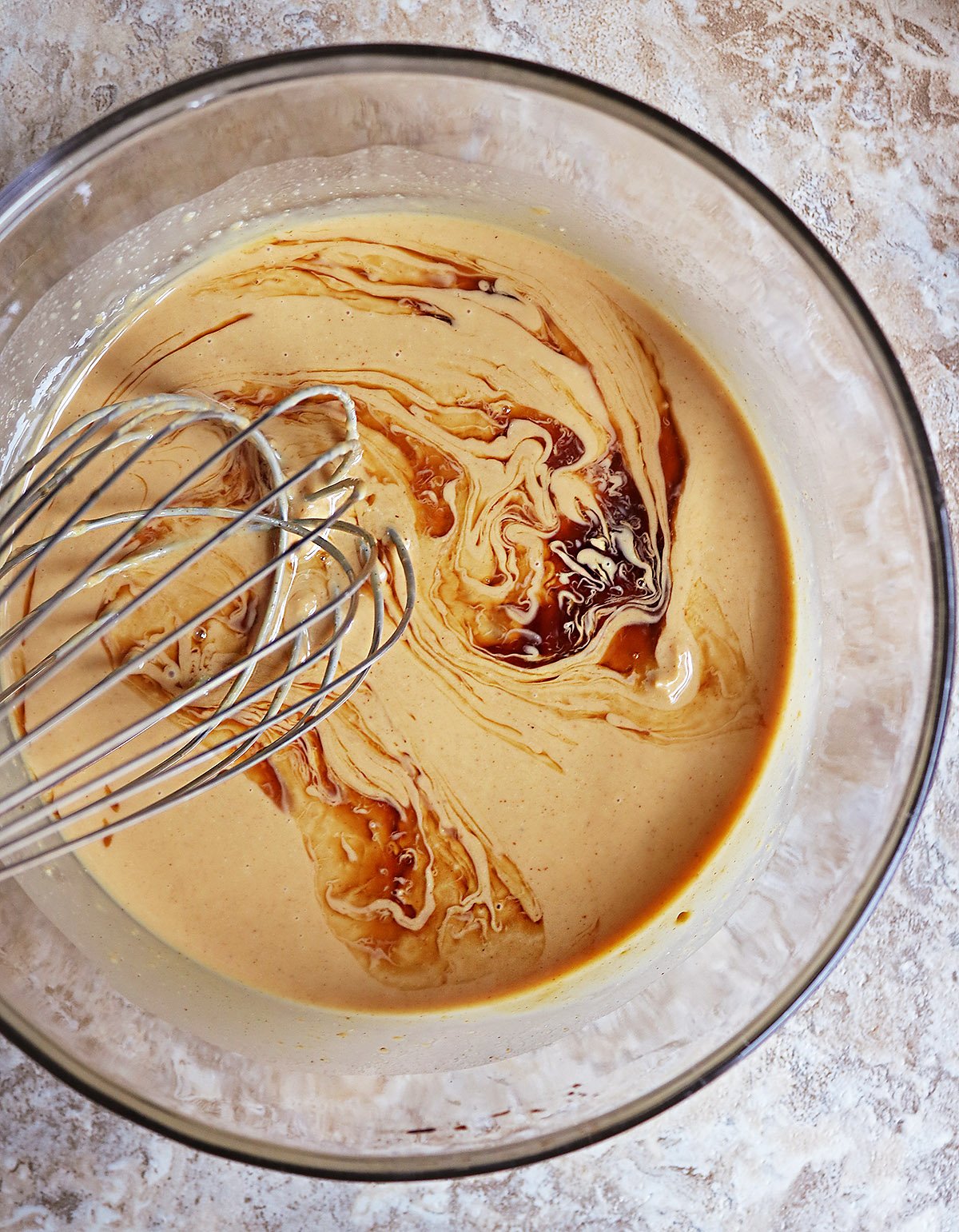 mIXING TOGETHER peanut butter, coconut oil, and vanilla IN A LARGE BOWL.