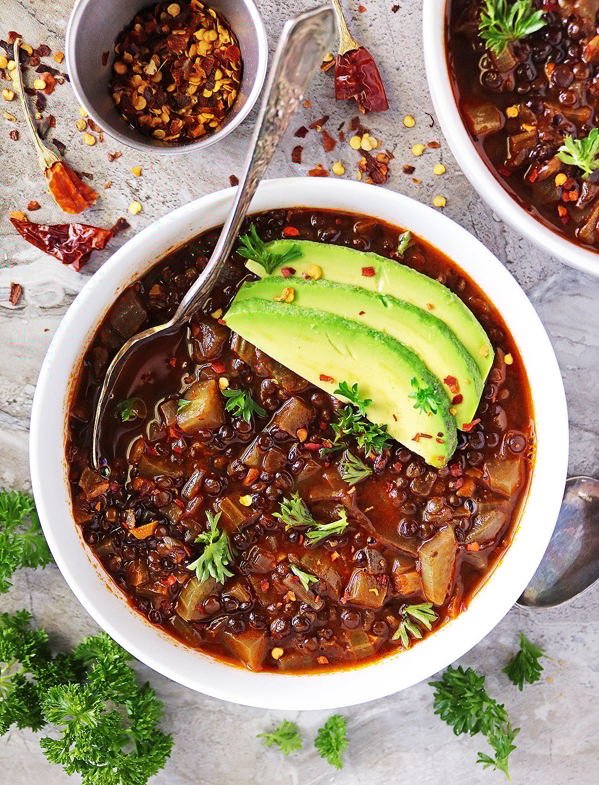 black lentils cooked in a spiced tomato broth to make a delicious black lentil soup.
