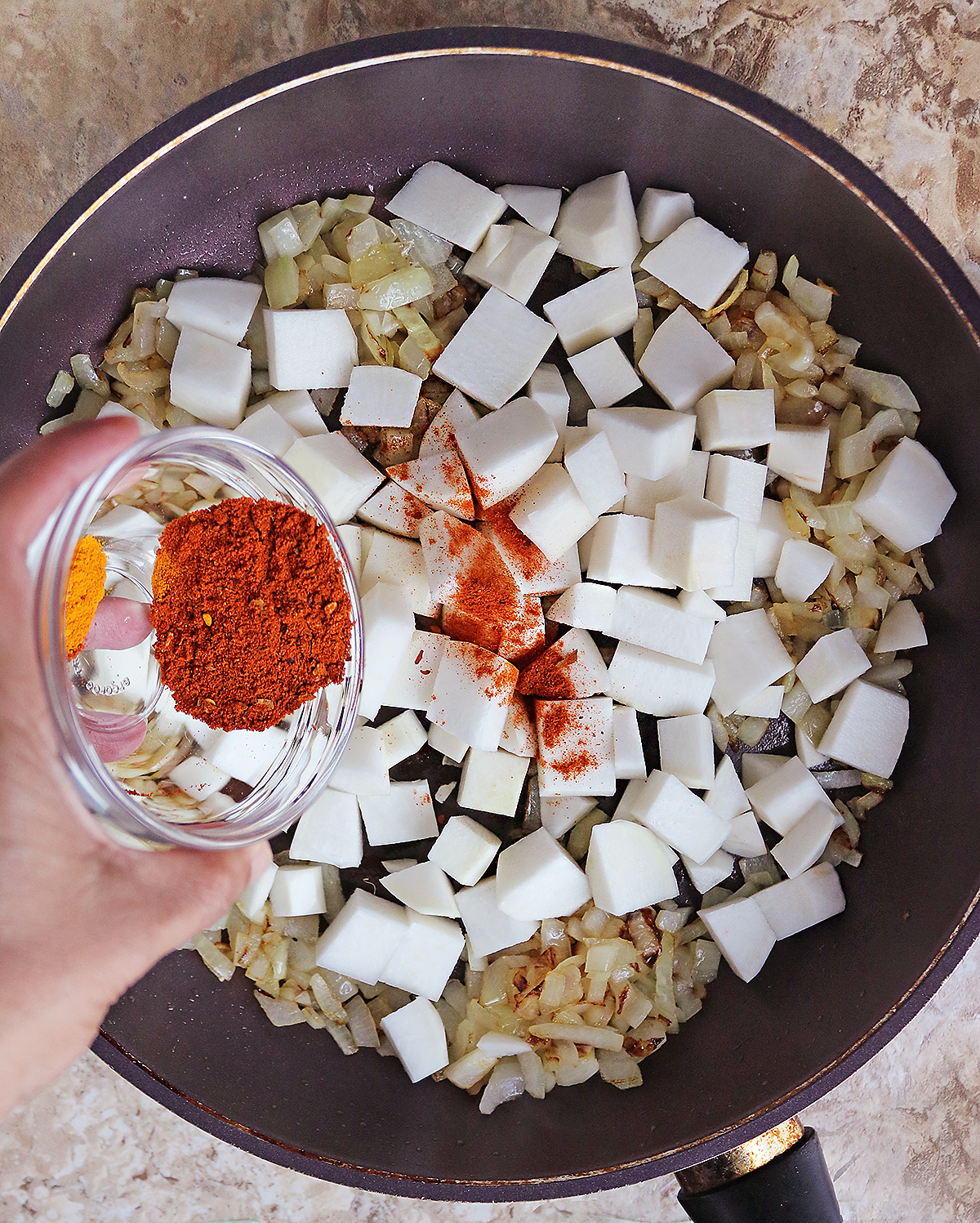 Pan roasting the turnips with spices and onions