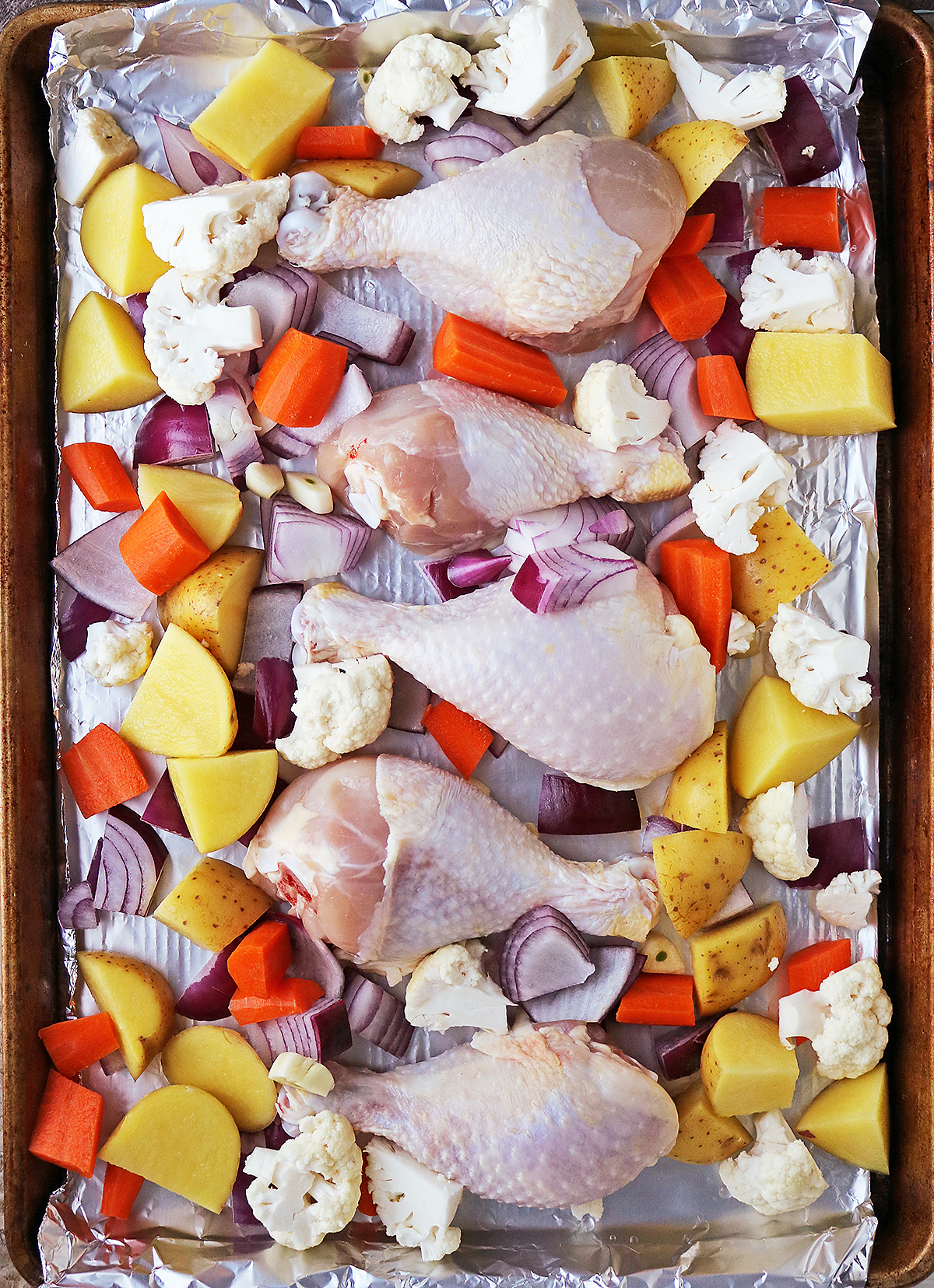 VEGGIES AND CHICKEN ARRANGED ON SHEET PAN