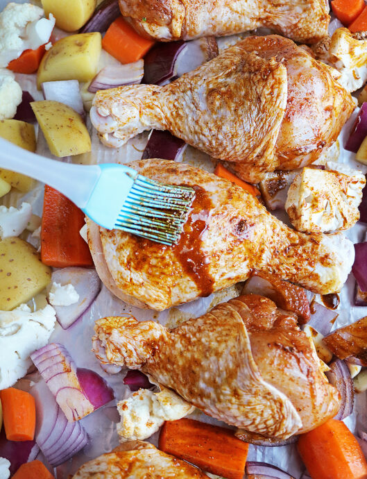 brushing veggies and chicken with delicious spice mix