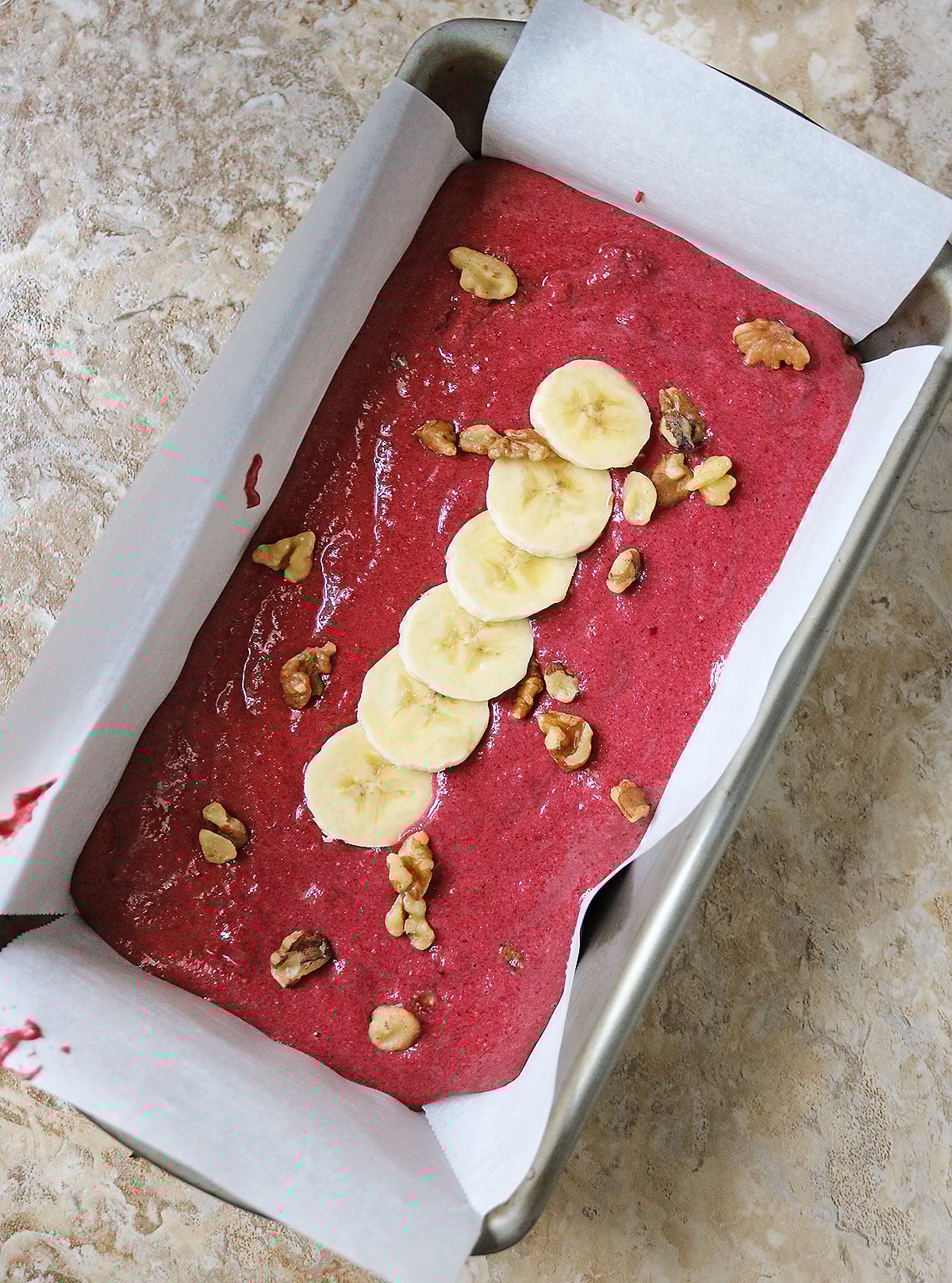 Beet banana bread batter in loaf pan ready to bake