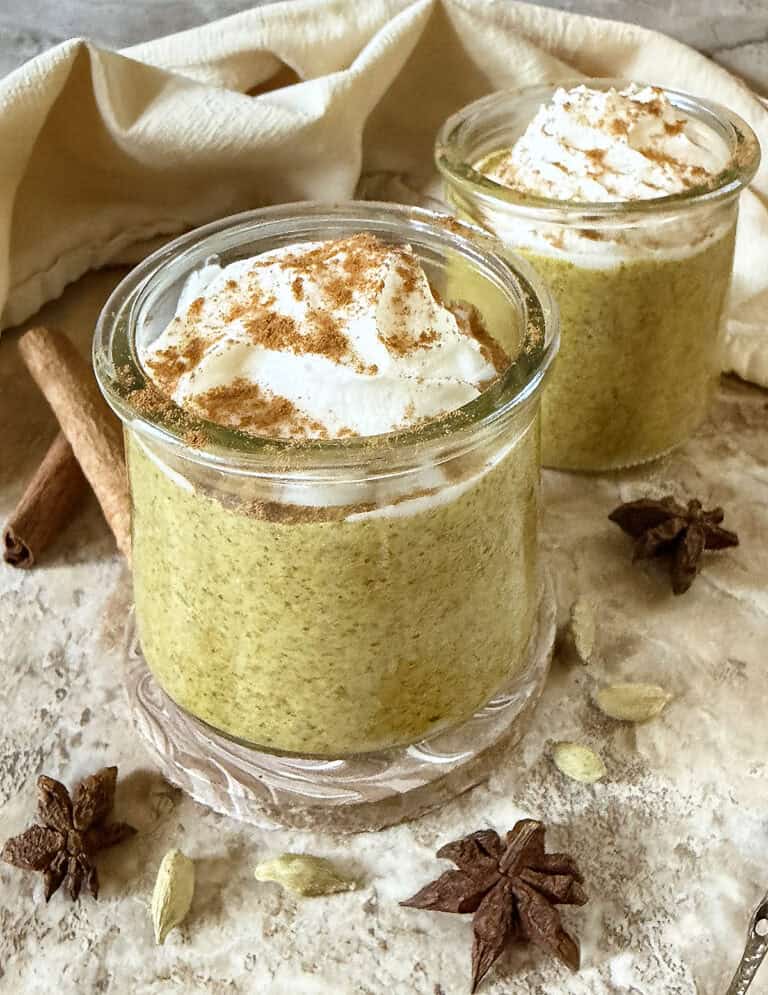 Two glass containers with Delicious Creamy Instant Golden Milk Chia Pudding