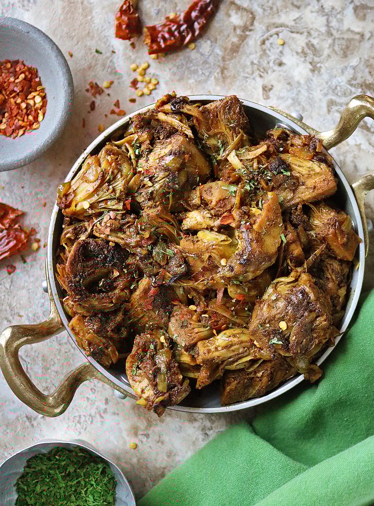 Easy Vegan Sautéed Jackfruit in a pan with handles and garnished with dried parsley and red pepper flakes.