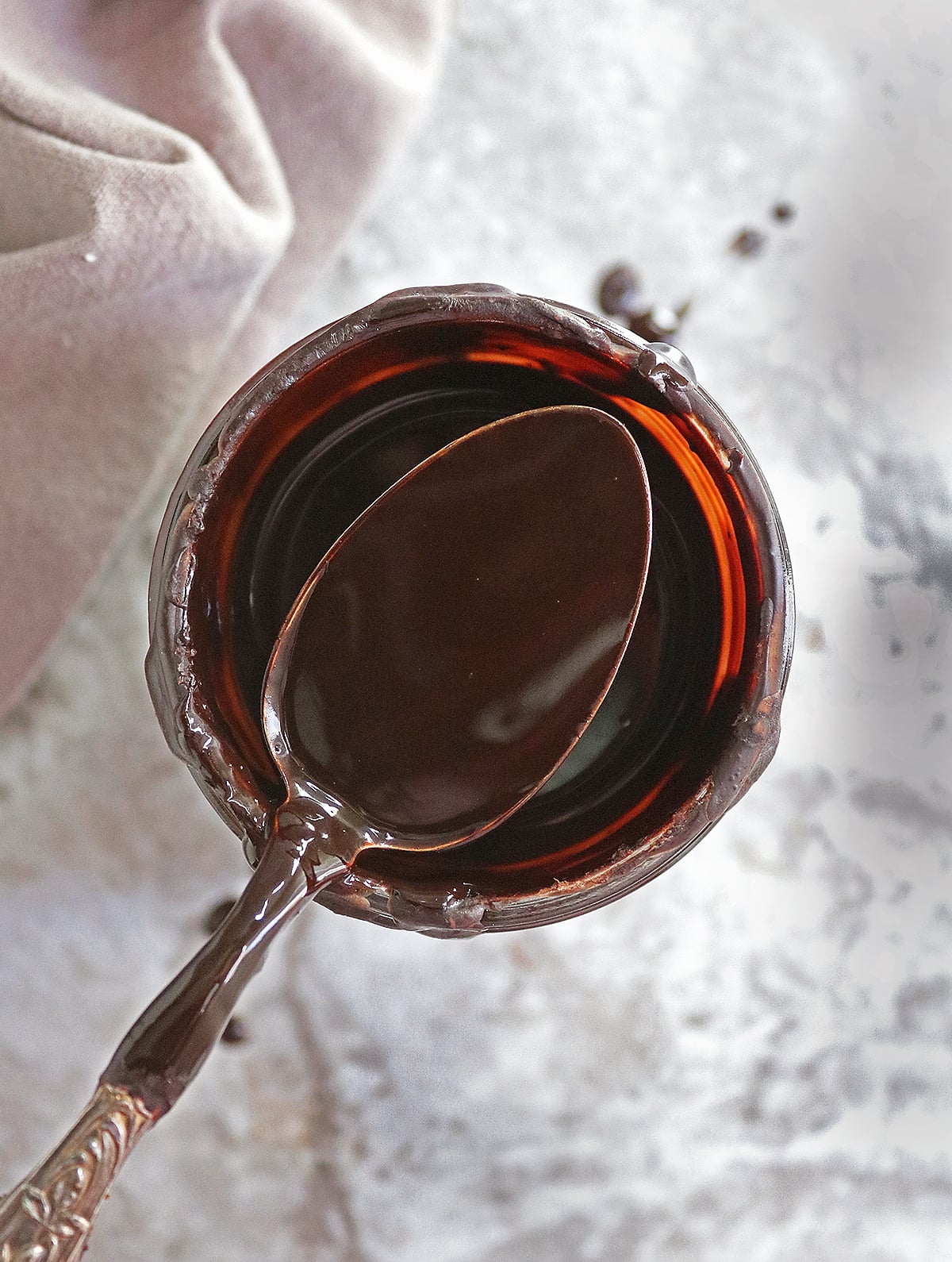 The best 5 minute homemade syrup in a mason jar, cooling down with a spoon on top of the jar.
