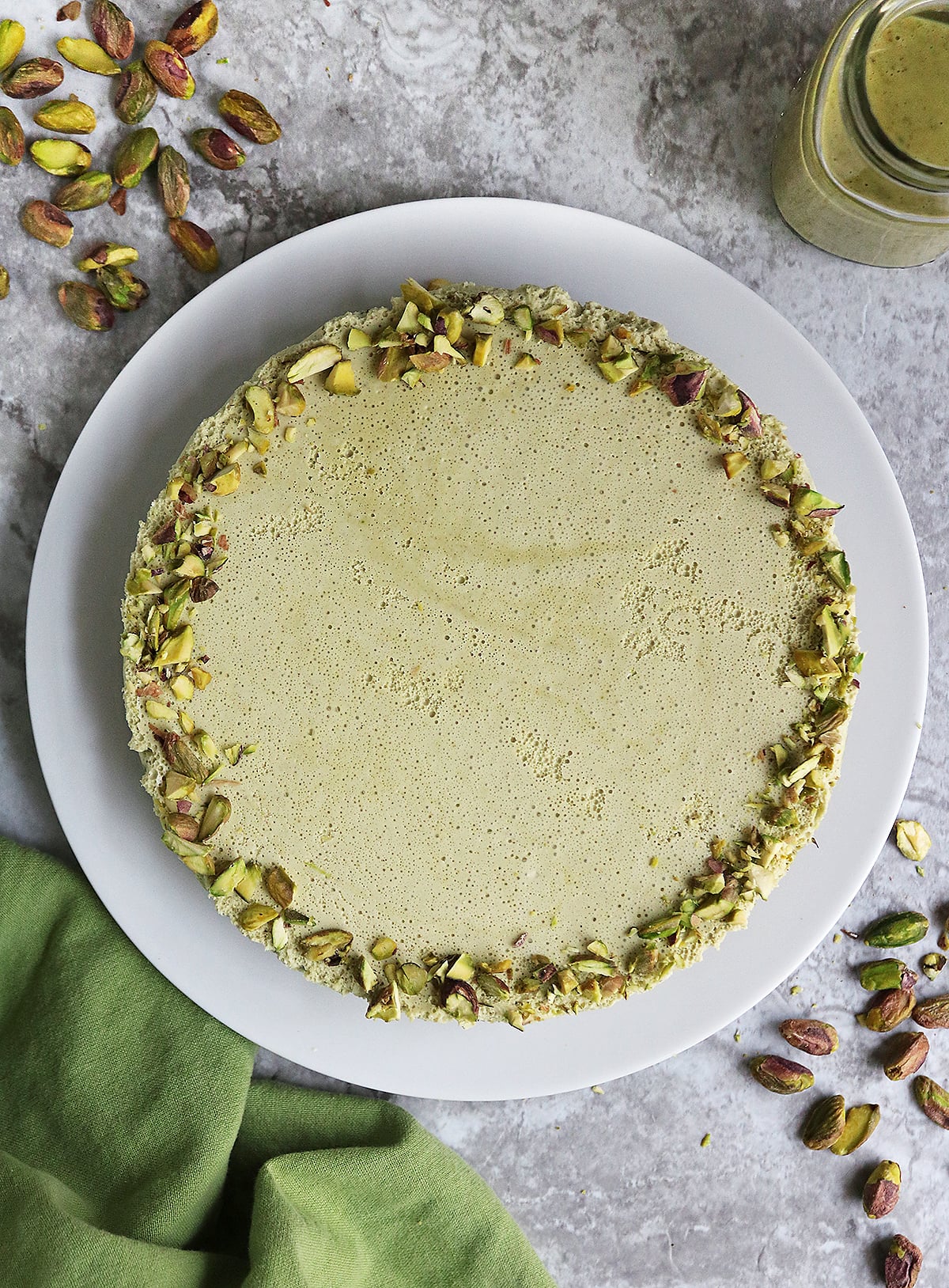 Delicious and creamy keto dessert with pistachios on a plate .