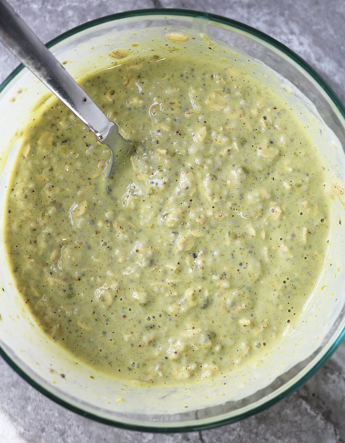 Mixing together all the ingredients to make pistachio overnight oats