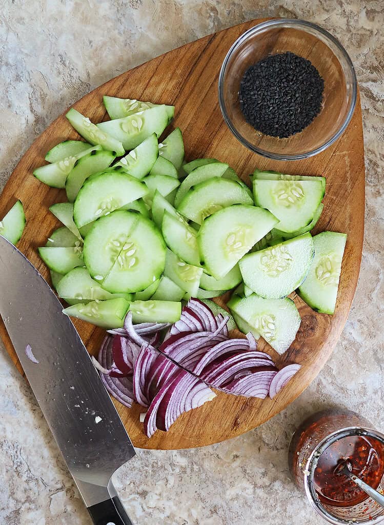 Prepping the cucumber and onion to make this refreshing and spicy salad