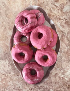 A silver serving tray with 8 of The best Naturally Colored Gluten-Free Baked Pink Doughnuts