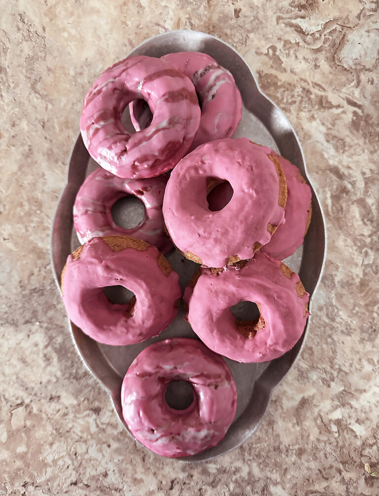 A silver serving tray with 8 of The best Naturally Colored Gluten-Free Baked Pink Doughnuts