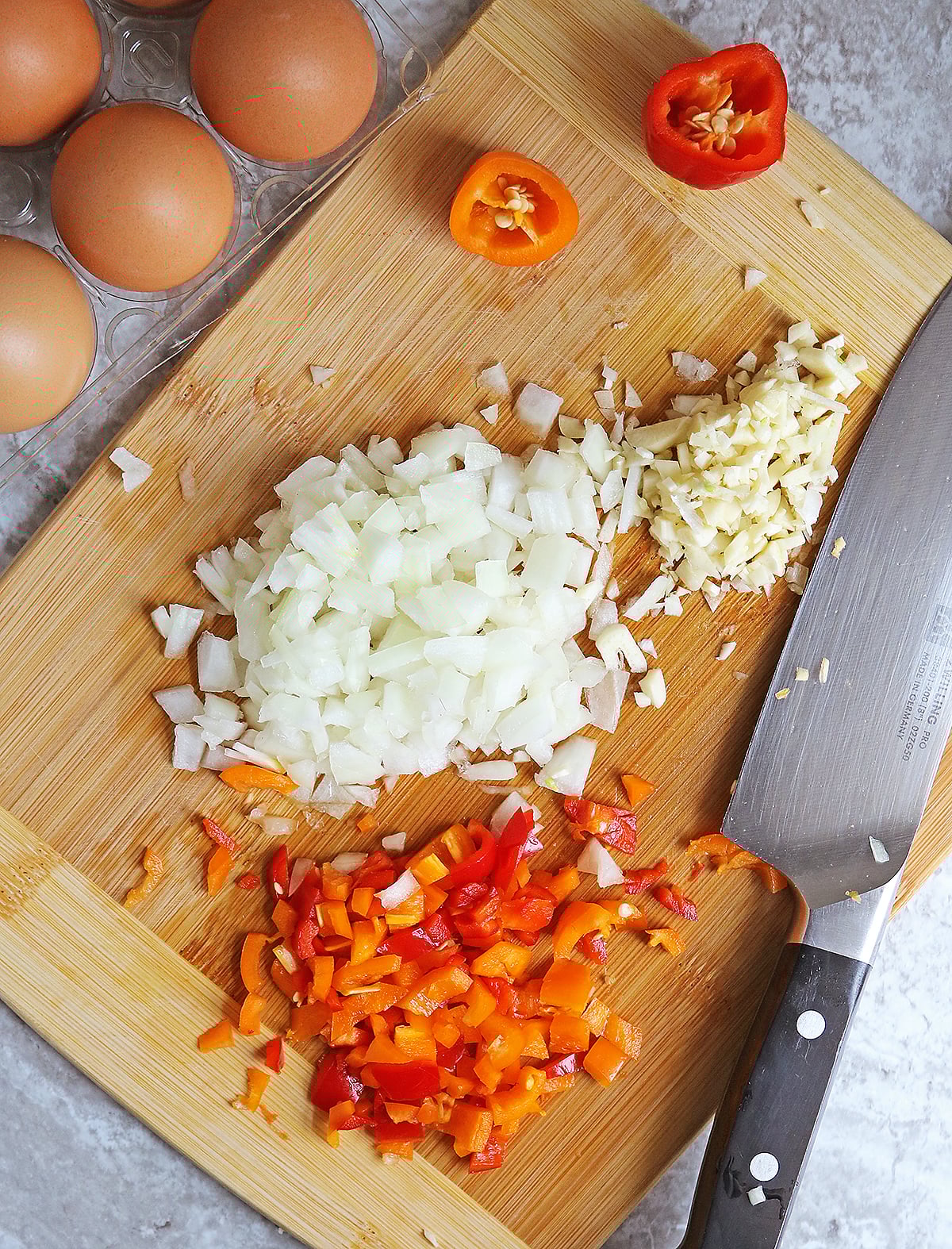 chopping the onions, garlic, and peppers