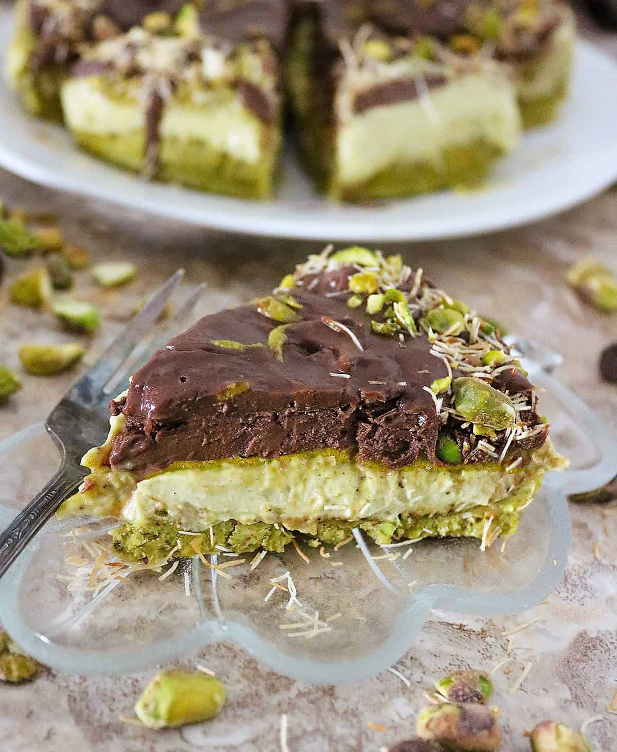 A slice of Dairy-free Dubai chocolate cheesecake on a glass plate.