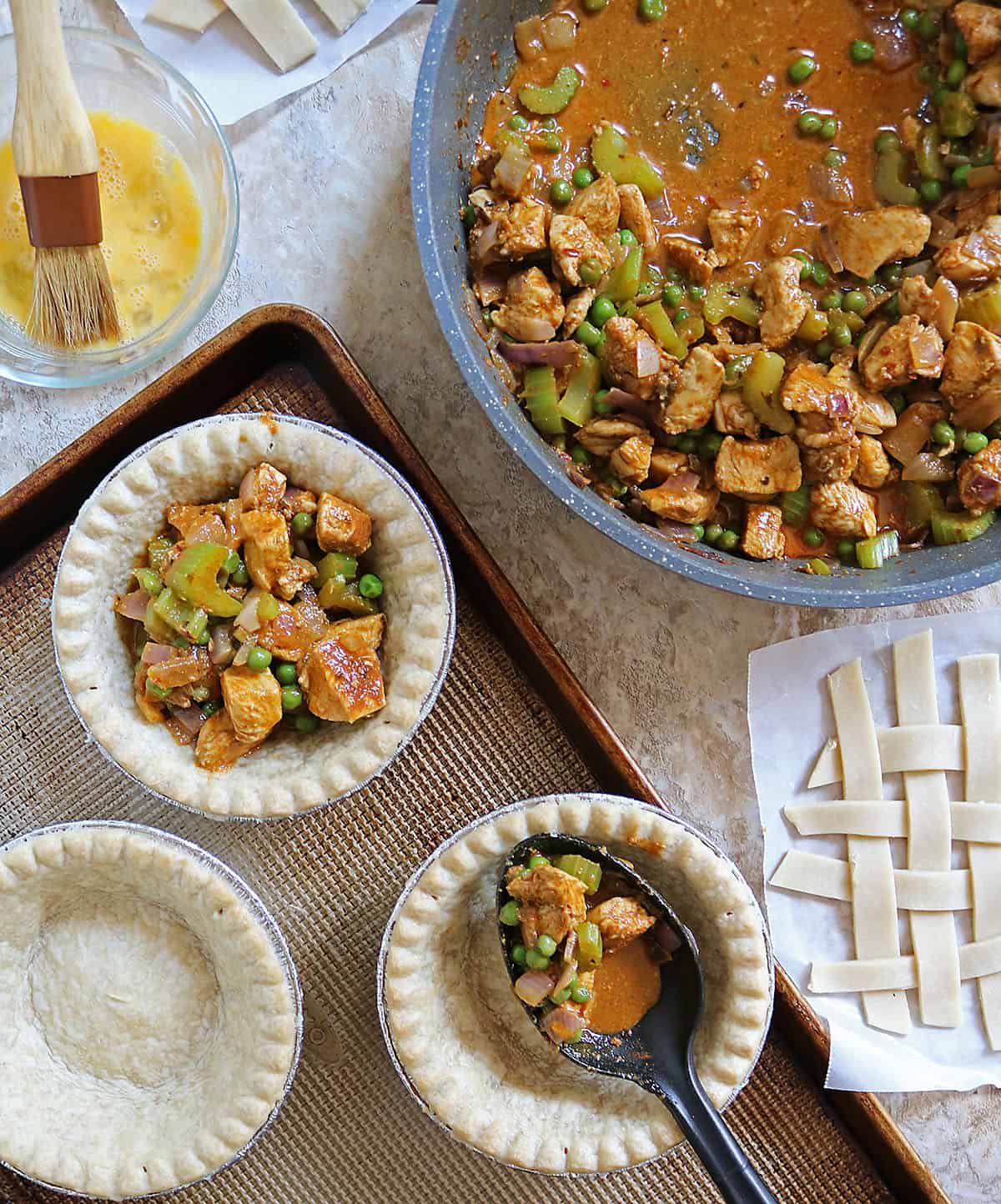 adding the chicken curry to the pie shells