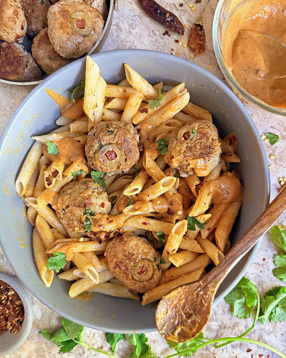 a large bowl with delicious pumpkin turkeyballs with pasta and harissa pumkin sauce.
