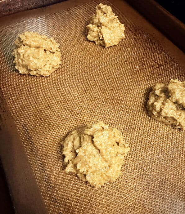 Raw muffin top dough balls on a baking sheet ready for baking.